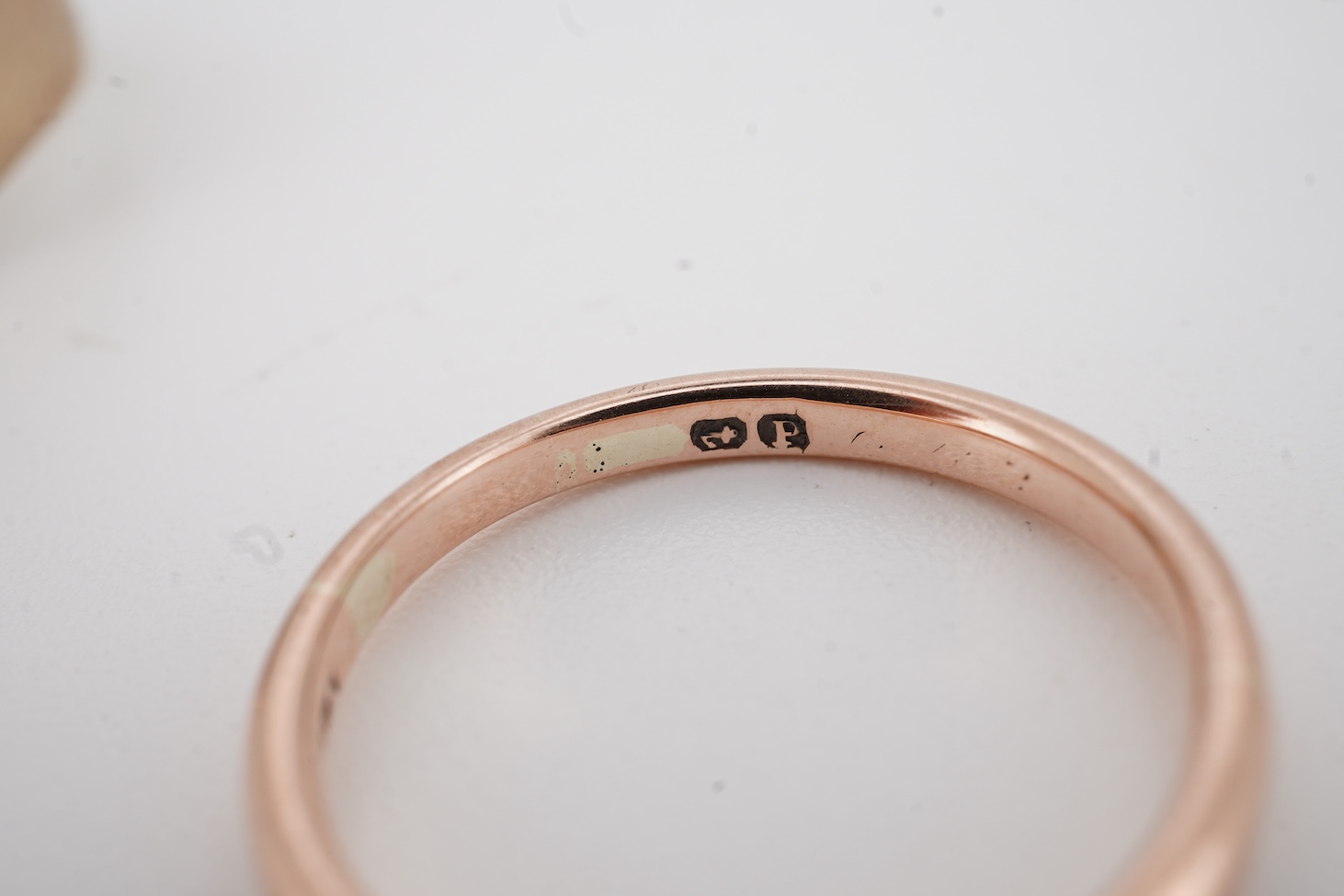 A 1940's platinum wedding band, with engraved inscription, size M, 2.3 grams together with a 9ct signet ring and a yellow metal wedding band.